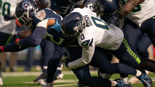 Tennessee Titans running back Derrick Henry (22) runs for a first down against Seattle Seahawks linebacker Devin Bush (0) during their game at Nissan Stadium in Nashville, Tenn.